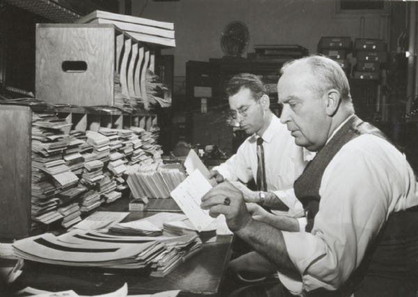 City Treasurer D.J. Leigh with an associate, sorting records.