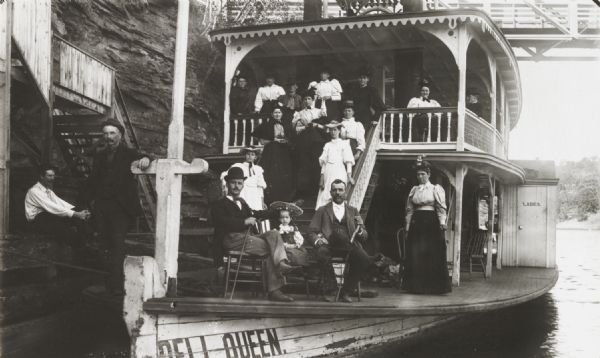 Group of tourists and crew members on the bow deck of the <i>DELL QUEEN</i>, an excursion boat that operated on the Wisconsin River at Wisconsin Dells.