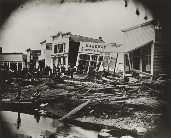 View of flood damage, showing wrecked buildings along the Wisconsin River waterfront.