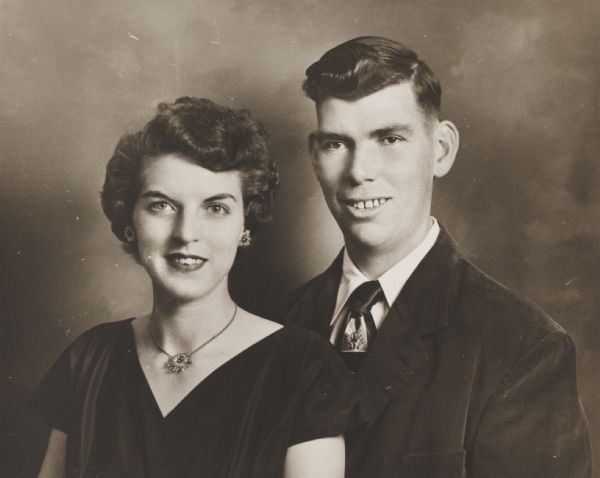Double quarter-length portrait of a smiling young couple. 
