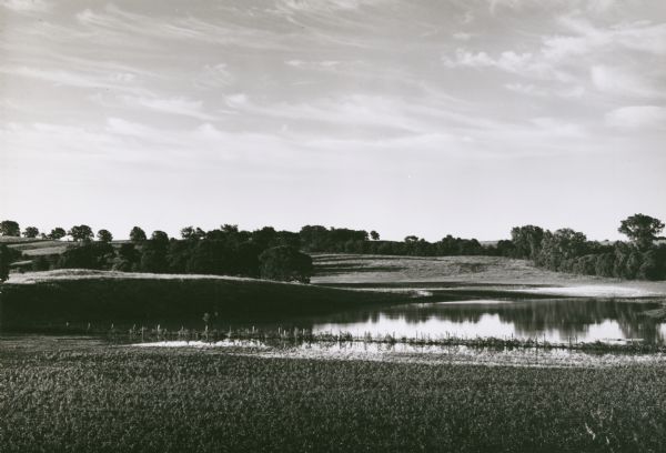 View of landscape at the top of Rocky Glen Road, looking over flooded fields at sunrise.