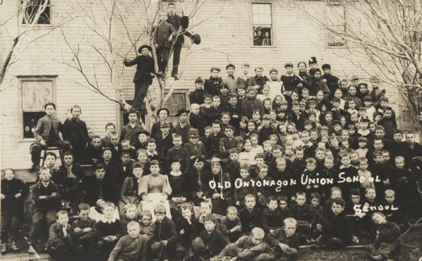 Large group of school boys and school girls with their teacher at the “old” Ontonagon Union School.