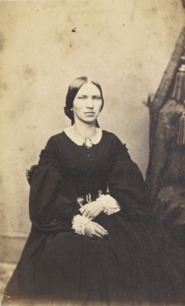 Carte-de-visite seated portrait of Mrs. Gerhard Inbusch. She is wearing a large brooch with a lace collar.