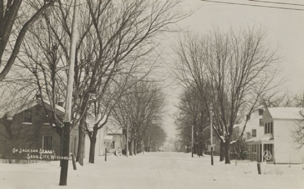 Winter scene of snow-covered Jackson Street, Sauk City, Wisconsin.