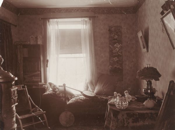 Interior of a student's room at Downer (women's) College. Two banjos rest on the chaise in front of the window.