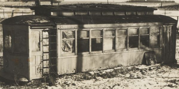 Exterior view of old streetcar stabilized, adapted and furnished as living quarters.