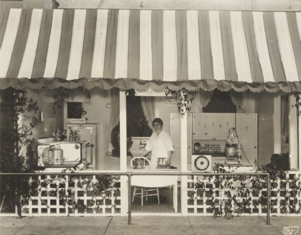 Demonstration booth in the Women's Building at the Wisconsin State Fair, showing electrical kitchen equipment.

