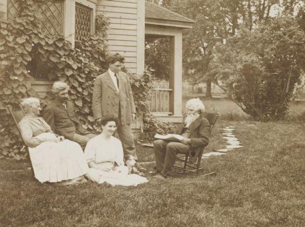 Members of the Lloyd Jones family informally gathered on the lawn outside their house. Names (l to r) Mrs. (Hannah) John Lloyd Jones, Richard Lloyd Jones, Miss Mary Lloyd Jones (foreground), Thomas Lloyd Jones, John Lloyd Jones.
