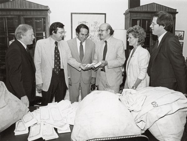 Fred Wertheimer, (fourth from the right) of Common Cause, delivers bags of citizen petitions to Wisconsin Congressman David R. Obey, (third from the left), in support of his ongoing efforts to reform the financing of political campaigns.