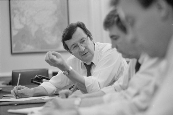 Congressman David R. Obey, chair of the Foreign Operations Subcommittee of the House Appropriations Committee, discussing foreign policy issues with his staff. A map is on the wall in the background.