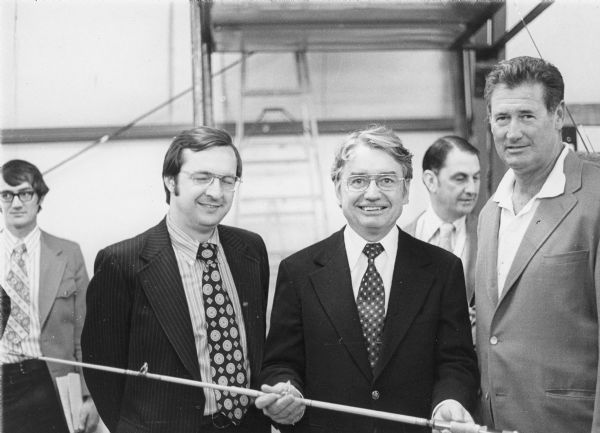 As part of a national economic development program for northern Wisconsin, former baseball star Ted Williams, then a representative of a fishing tackle company, met Wisconsin Governor Patrick J. Lucey and Congressman David R. Obey. Governor Lucey is holding a fishing rod.
