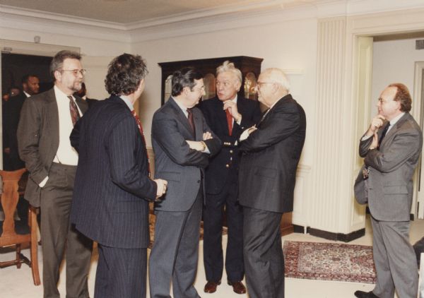 Les Aspin (second from the right) served as Secretary of Defense during the administration of President Clinton. He is seen here at the Pentagon holiday party chatting with two of his Wisconsin congressional colleagues. To Aspin's right are Robert Kastenmeier and David R. Obey. The other people in the photograph are unidentified.