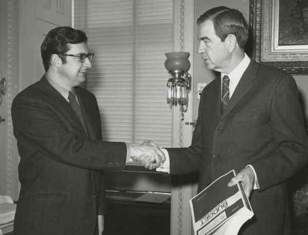Congressman George Mahon of Texas, chairman of the House Appropriations Committee, welcomes newly-appointed Congressman David R. Obey to the committee and its Interior subcommittee. Obey's appointment coming while still in his first term was a plum assignment. Obey would go on to eventually become chair and ranking Democratic member of the powerful committee.