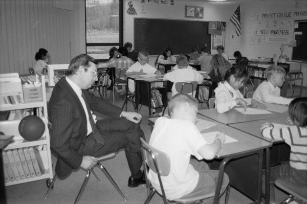 Congressman David R. Obey observes the "Charlie Program" in action at an elementary school in his district. Obey was a strong supporter of education and educational reform.