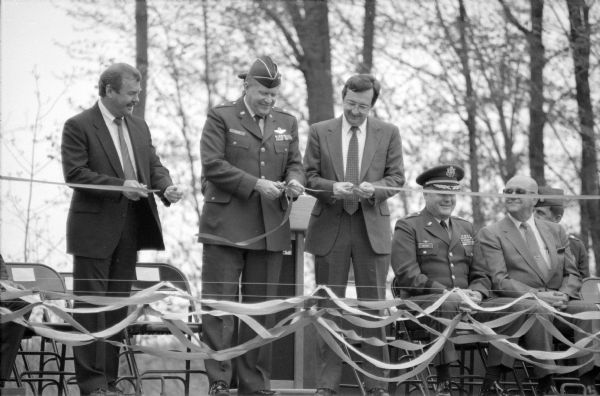 Wisconsin Adjutant General Jerald Slack cuts the ribbon to dedicate a new armory. With him (left) are Abbotsford Mayor, Duane Grube, and Congressman David R. Obey. Obey, as a member of the powerful House Appropriations Committee, was instrumental in securing the funds for the new facility even though they had been cut from the Administration's budget. The armory was to be the base for Abbotsford's Detachment 1, Company D, 724th Engineering Battalion.