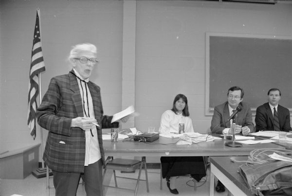 Congressman David R. Obey of Wisconsin (seated, second from the right) listens while Virginia McGinley testifies at a public forum on health care. This was one of many public forums Obey conducted across his district during the 1990s concerning the rising costs of health care.