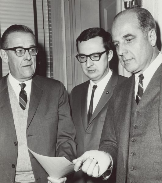 Senator Gaylord Nelson (right) with his home secretary and Democratic Party Chairman Louis Hanson (left) at Hotel Wausau event. With them is David R. Obey who won a special election in 1969 for Melvin's Laird's seat in Congress. Although undated it is likely the photograph dates from before the election and Nelson was there to support Obey's candidacy.