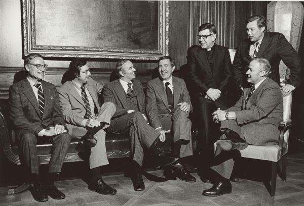 Democratic members of the Wisconsin congressional delegation with Morris Udall (center), probably at an event associated with Udall's attempted campaign for the Presidency in 1976. The Democrats are, (left to right) Henry Reuss, David R. Obey, Les Aspin, Robert J. Cornell, Bob Kastenmeier, and (seated) Alvin Baldus.