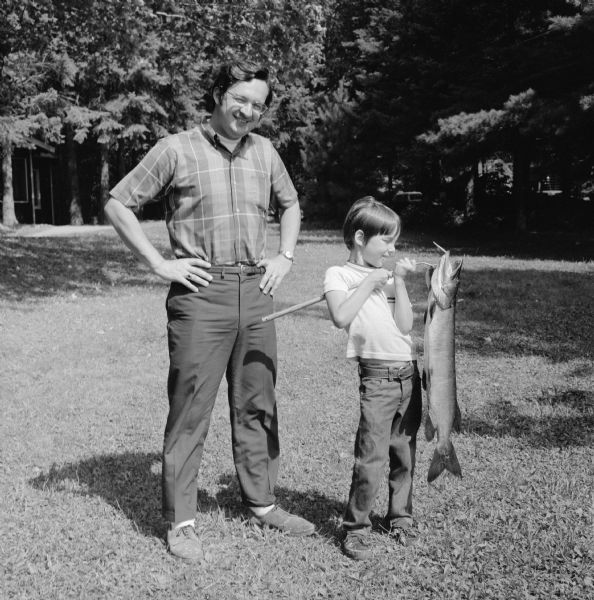 Wisconsin Congressman David R. Obey, his son Craig, and the catch of the day.