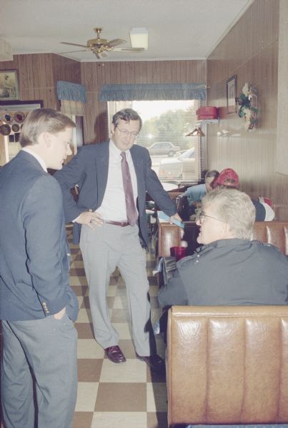 Congressman David R. Obey of Wisconsin campaigning in a cafe on Highway 29. With Obey is State Representative, Tom Springer.