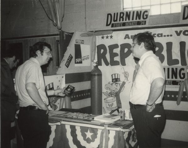 Campaigning at the Northern Wisconsin Fair, Democratic Congressman David R. Obey (left) of Wisconsin checked out the booth sponsored by the local Republican Party.