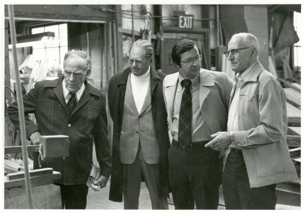 David Obey (2nd from right) and Harvey Dueholm (left) visit O'Mally's Manufacturing.