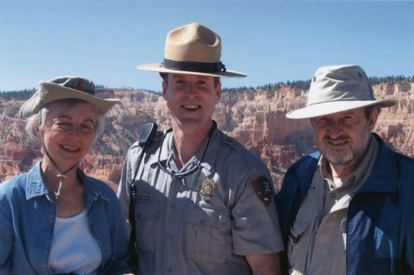 Joan Obey, Ranger Brent McGinn and Congressman David Obey at Bryce Canyon National Park. Canyon walls are in the far background.
