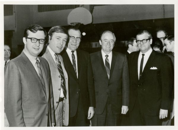 Congressman David Obey (left) and presidential candidate Vice President Hubert Humphrey (4th from left) pose with three other men.