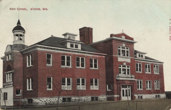 Colorized postcard view of the exterior of the high school. A bell tower is on the roof. Caption reads: "High School, Athens, Wis."