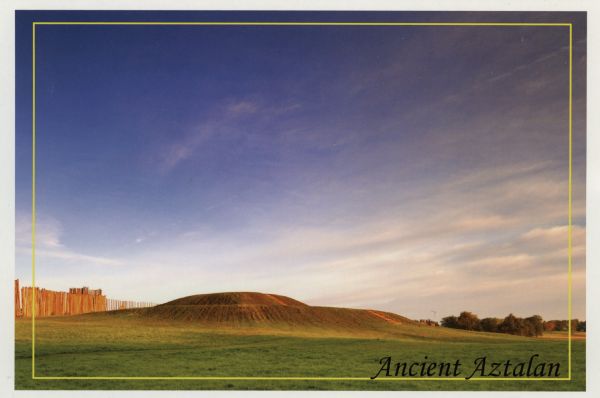 Photographic postcard view of one of the Indian mounds at Aztalan State Park. Steps lead up to the top of the mound from the right, and a tall fence is behind it on the left. Caption reads: "Ancient Aztalan."