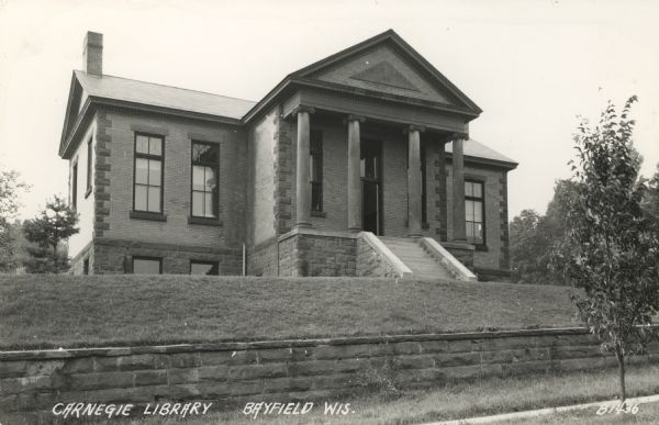 Exterior view of the front facade of the library. Caption reads: "Carnegie Library, Bayfield, Wis."