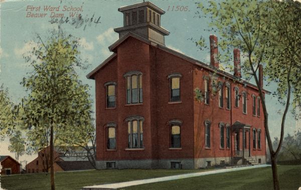 Exterior view of a school building. Caption reads: "First Ward School, Beaver Dam, Wis."