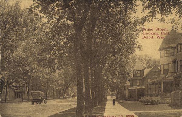 View down a tree-lined street in a residential neighborhood featuring large houses with porches. There is an automobile driving down the street and a man walking down the sidewalk. Caption reads: "Broad Street, Looking East, Beloit, Wis."