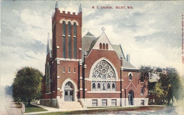Colorized postcard view of the exterior of the Methodist Episcopal Church. Gothic arches are over the doors and windows. Caption reads: "M. E. Church, Beloit, Wis."