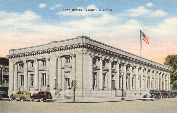 Colorized postcard view of the exterior of the Post Office. A traffic light is on the corner and cars are parked along the curb. Caption reads: "Post Office, Beloit, Wis."