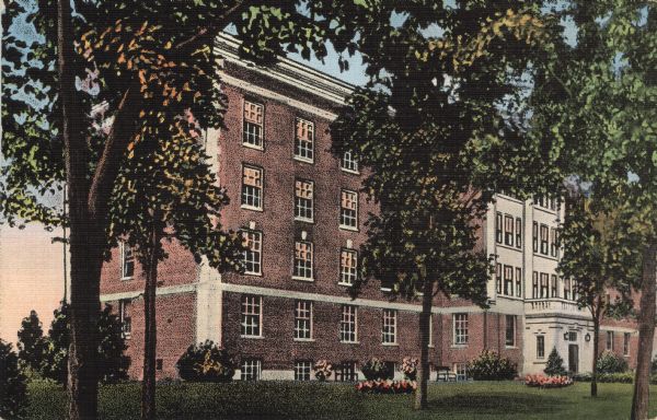 Colorized postcard view of the exterior of the Municipal hospital. Flowers and trees are on the lawn.