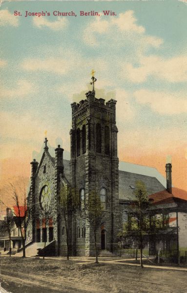 Colorized postcard view from street of a stone church with a rose window and steps up to the entrance. Caption reads: "St. Joseph's Church, Berlin, Wis."
