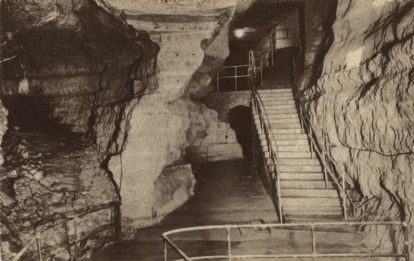 Photographic postcard view of the stairs leading to the exit of Cave of the Mounds.