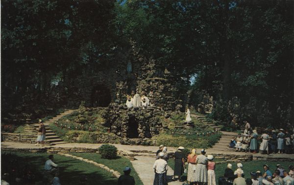 Elevated view of a group of worshipers at a shrine featuring a Madonna.