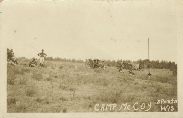 View of troops and caissons on a hillside at Camp McCoy. Caption reads: "Camp McCory, Sparta, Wis."