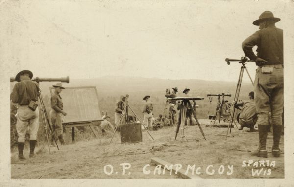 Photographic postcard view of a group of surveyors working on a hilltop at Camp McCoy. Caption reads: "O. P. Camp McCoy, Sparta, Wis."