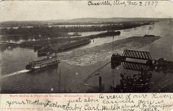 Elevated photographic postcard view of a paddle steamer towing rafts loaded with logs through an open pontoon bridge on the Mississippi River. Caption reads: "Raft Scene & Pontoon Bridge, Mississippi River."
