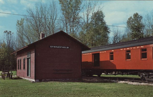 Color postcard of the depot and a railroad car at Stonefield Village.