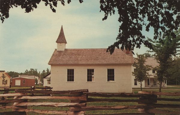 Color postcard of the side of the village church at Stonefield. A split-rail fence is in the foreground.