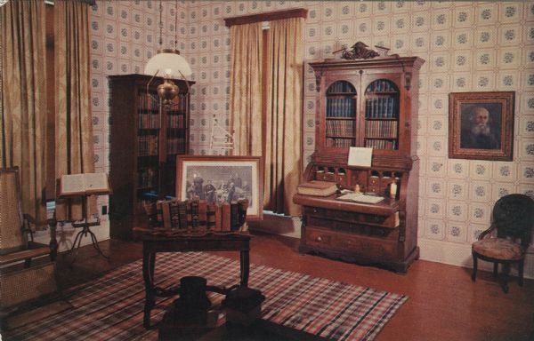 Color postcard of interior view of the office the Dewey Home featuring the desk and bookshelves.