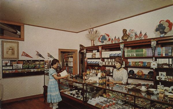 Color postcard of the interior of the book and stationery store at Stonefield.