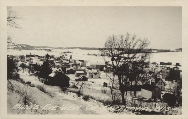 Elevated view from hill towards Cazenovia in winter. Caption reads: "Bird's-Eye View, Cazenovia, Wis."