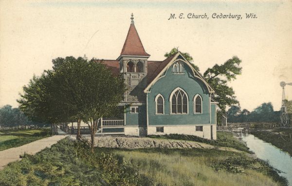 Hand-colored view of the Methodist Episcopal Church on Portland Avenue. Cedar Creek flows behind it. Caption reads: "M.E. Church, Cedarburg, Wis."