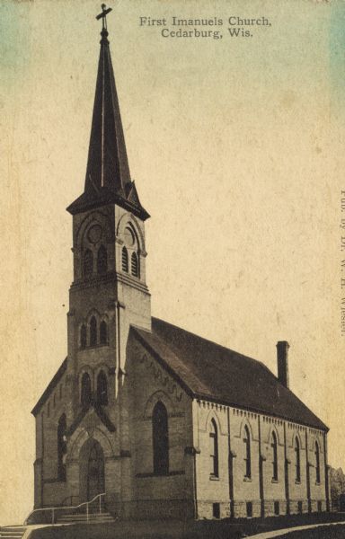Hand-colored view of First Imanuels Church. A brick building with arched windows, bell tower and steeple. Caption reads: "First Imanuels Church, Cedarburg, Wis."
