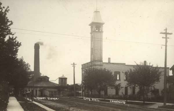 View of the power house and city hall in Cedarburg. The power house has a smokestack and the city hall has a bell tower. Caption reads: "Power House; City Hall; Wis."